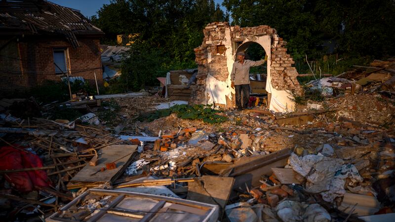 FILE - Vladimir, 66, stands next to the wreckage of his house after being bombed by Russians...