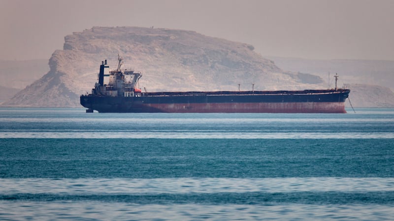 A bulk cargo ship sits at anchor in the Strait of Hormuz off Bandar Abbas, Iran, Saturday, May...