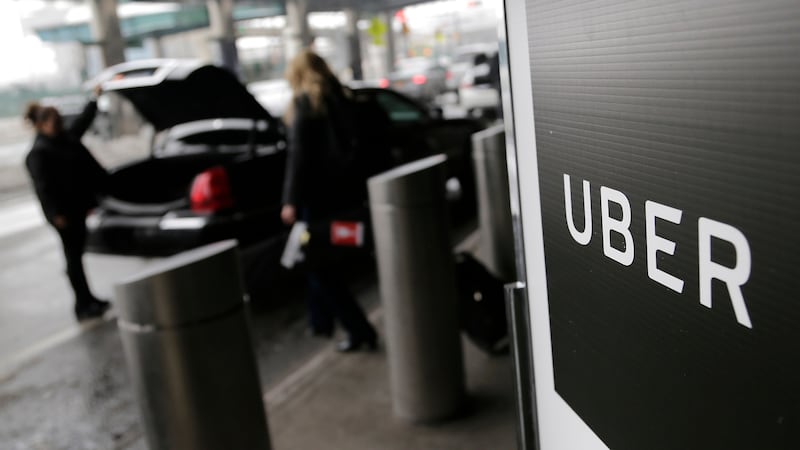 FILE - Uber pickup.